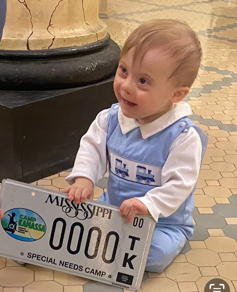 child with special needs holding MTK car tag