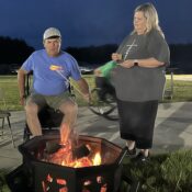 Adult campers roasting marshmallows at Camp Kamassa