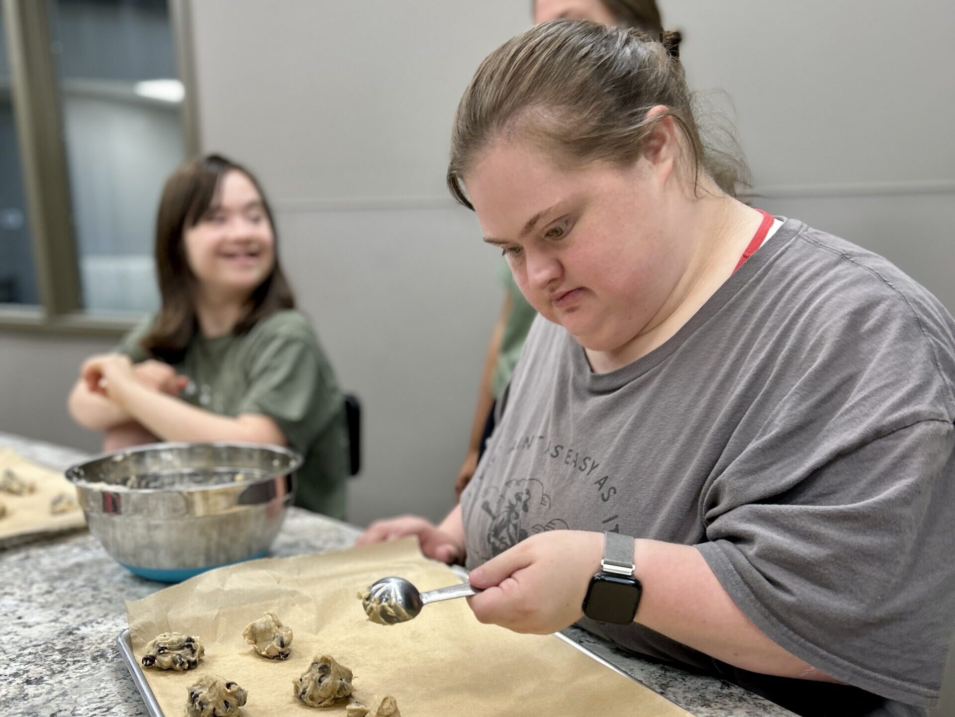 Camper making cookies in teaching kitchen at Camp Kamassa.