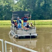 Campers taking a ride on the pontoon boat at Camp Kamassa.