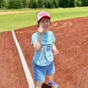 Kamassa camper on the baseball field giving a "thumbs up."