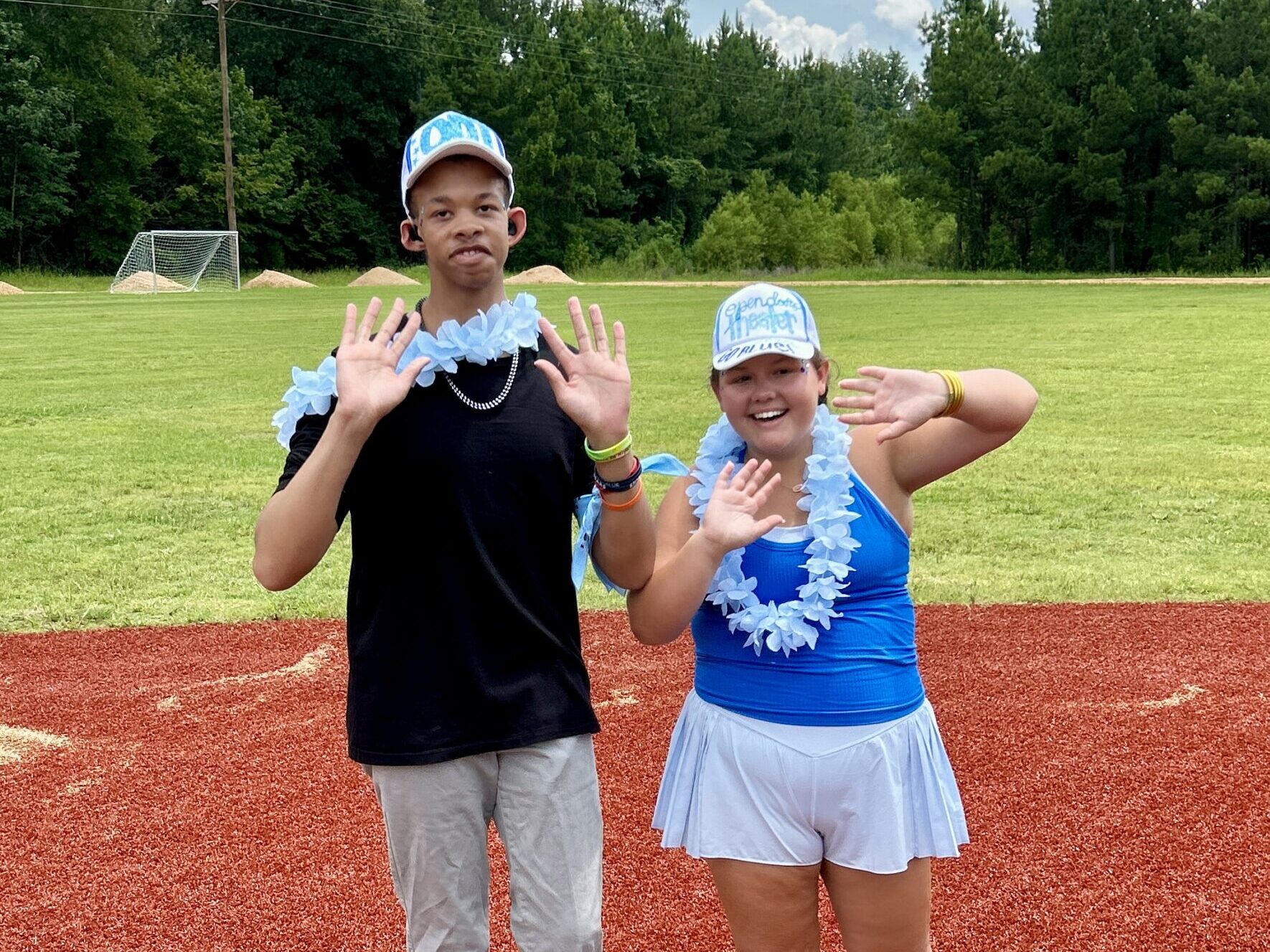 Camper and volunteer on the baseball field at Camp Kamassa.