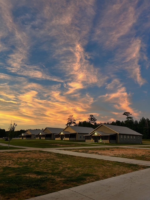 Sun setting over cabins at Camp Kamassa.