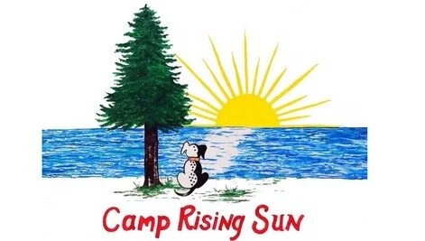 Logo for Camp Rising Sun. Logo includes a sunset, tree, water and dog.