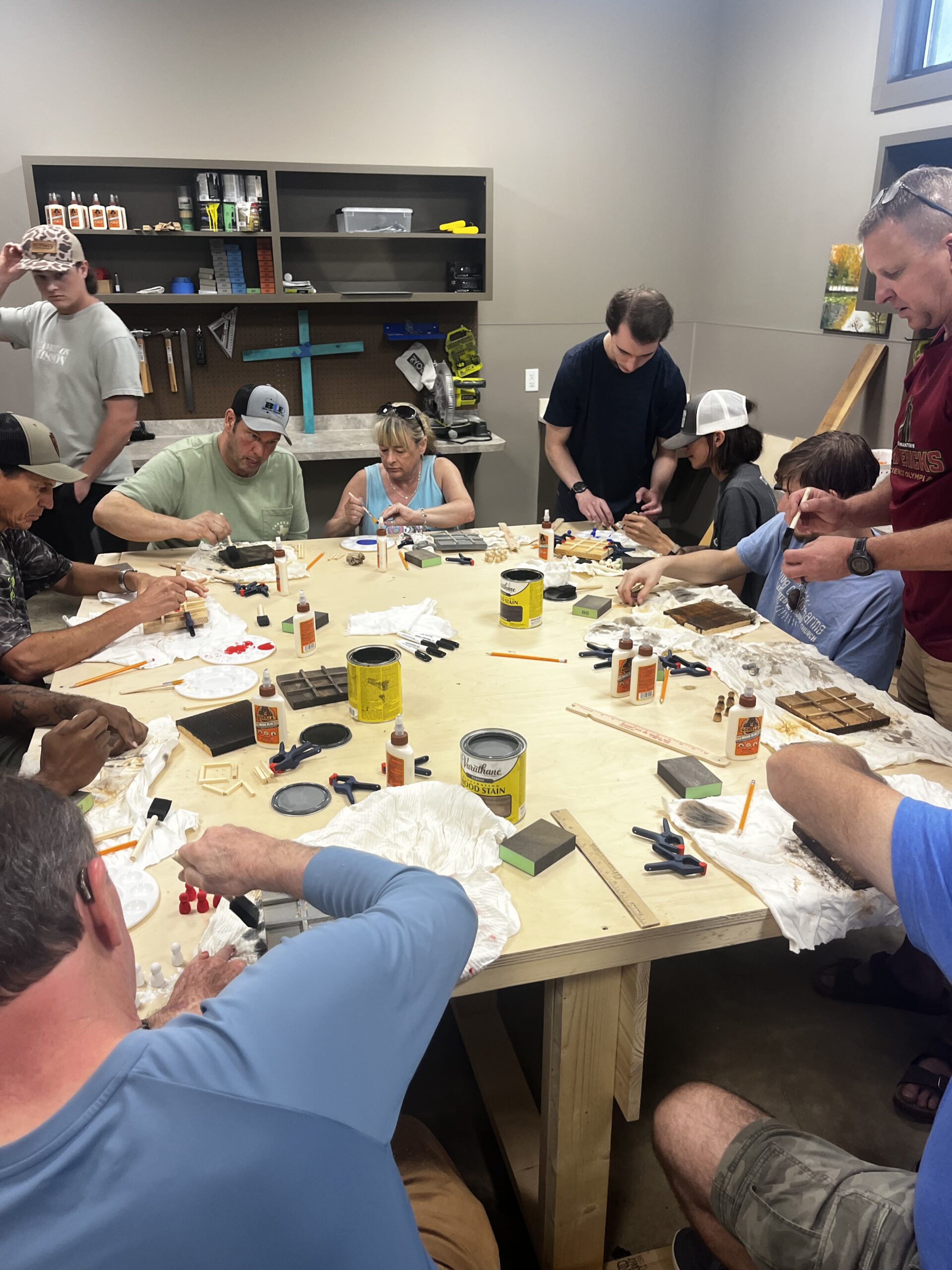 Campers enjoying woodworking projects at Camp Kamassa.