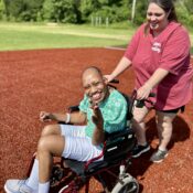 Camper participating in relay race on the baseball field at Camp Kamassa.