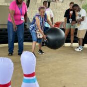 Camper playing giant bowling at Camp Kamassa.