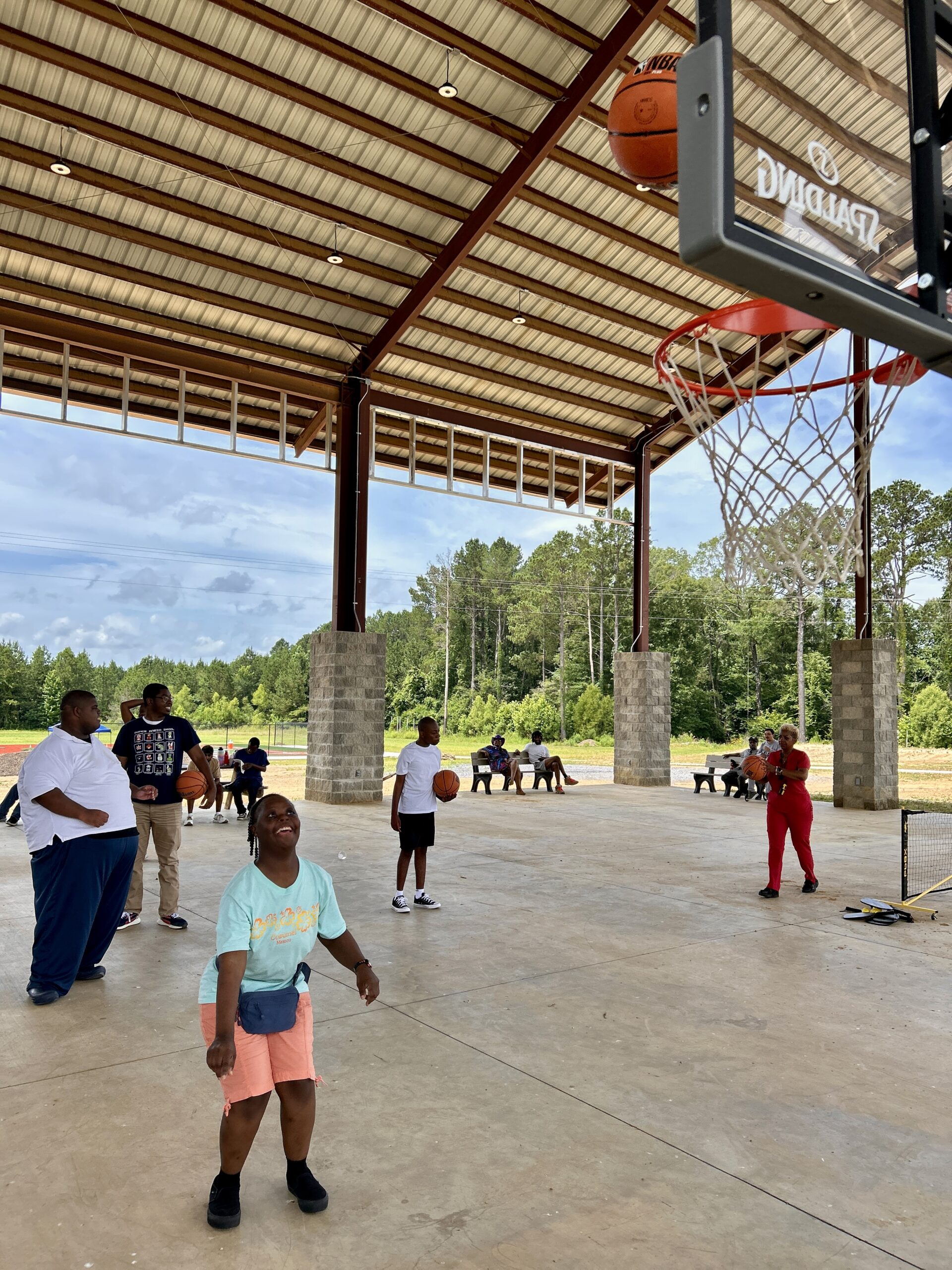 Campers play basketball at the Camp Kamassa pavilion.