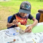 Camper painting ceramics project at Camp Kamassa.