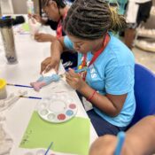 Camper painting ceramics project at Camp Kamassa.