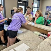 Families turning in medications with med staff in Camp Kamassa's infirmary