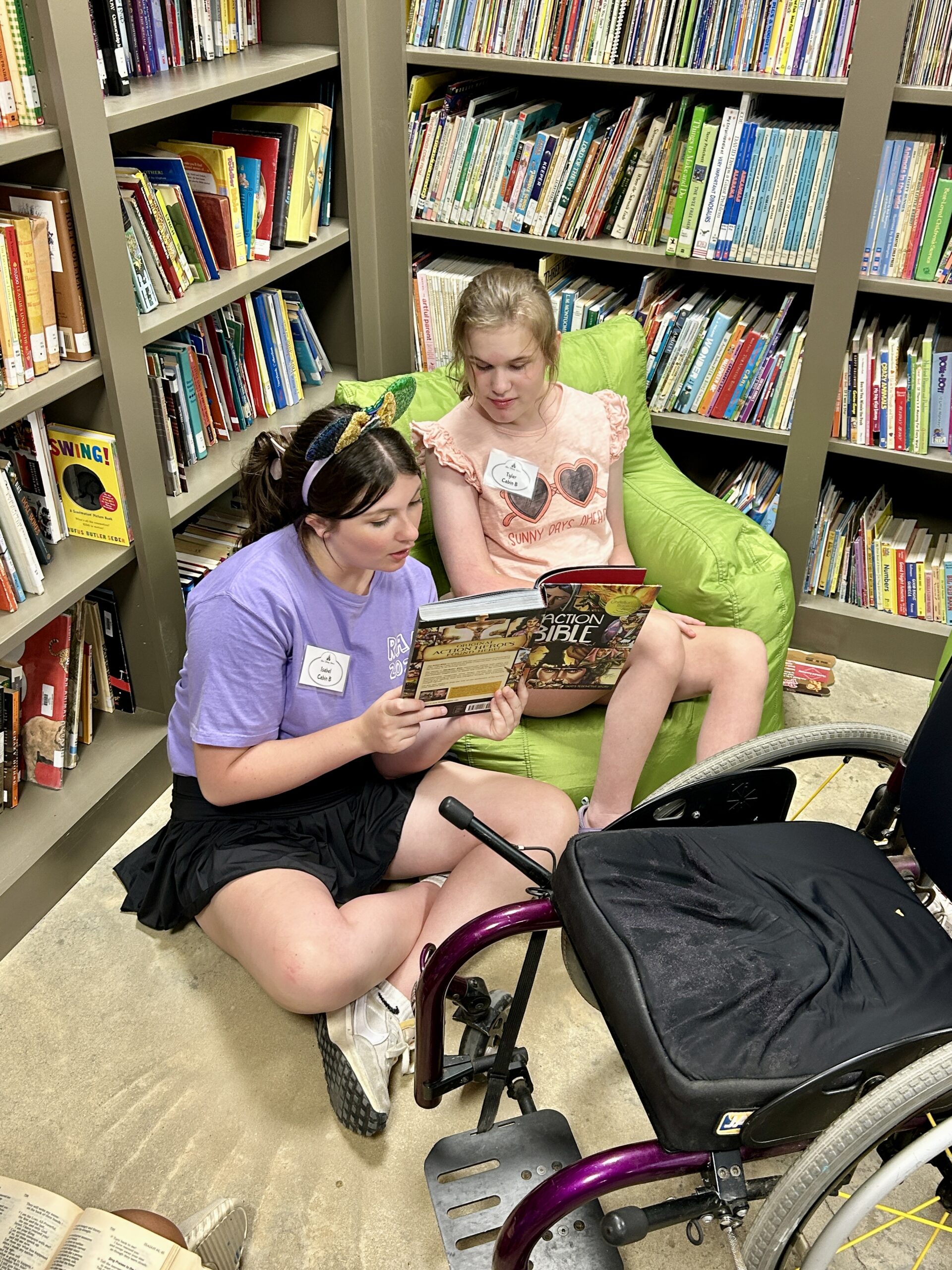 Counselor reading to camper in the library at Camp Kamassa.