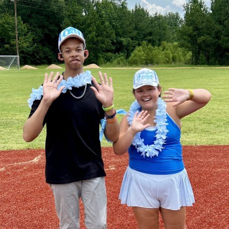 Camper and volunteer on the baseball field at Camp Kamassa.